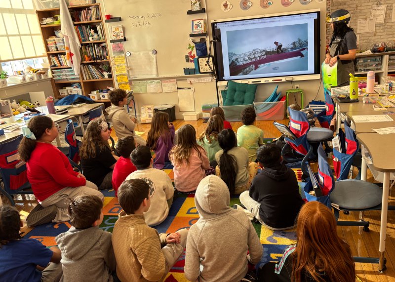 Teacher Lauren Graves shows a short video explaining different types of boards and equipment used for snowboarding.